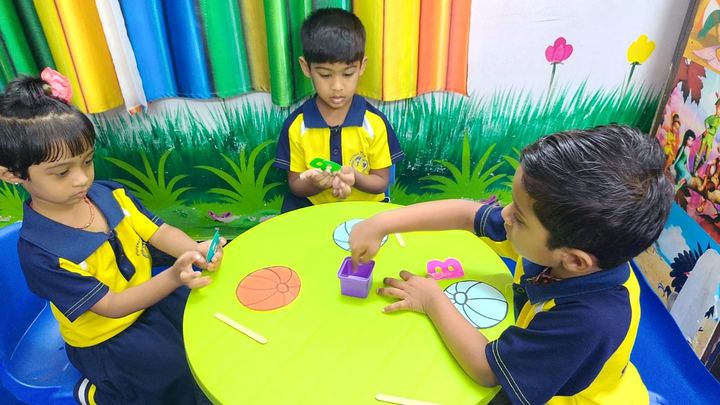 Children making art at a classroom table