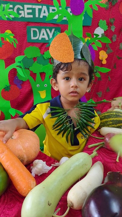 A child dressed as a leafy tree