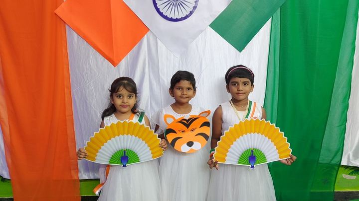 Children holding tricolor crafts